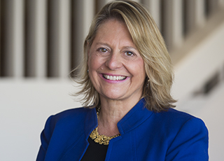 President Laura Walker - woman with blonde hair wearing a blue blazer
